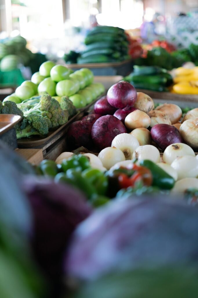 A colorful array of fresh vegetables displayed at an outdoor market.