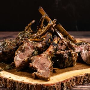 Delicious herb-crusted lamb chops on a rustic wood platter, perfect for elegant dining.